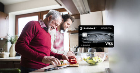 Two people cooking together in a kitchen, preparing a salad - Scotia Momentum VISA Infinite Card