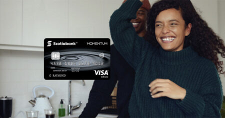 A smiling couple dance in a kitchen - Scotia Momentum VISA Infinite card