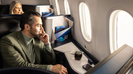 WestJet Business Class man looking out window of plane