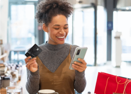 PC Financial credit cards - woman with phone and card