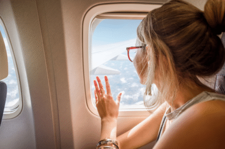 Woman looking out airplane window