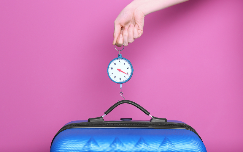 Save on baggage - suitcase being weighed
