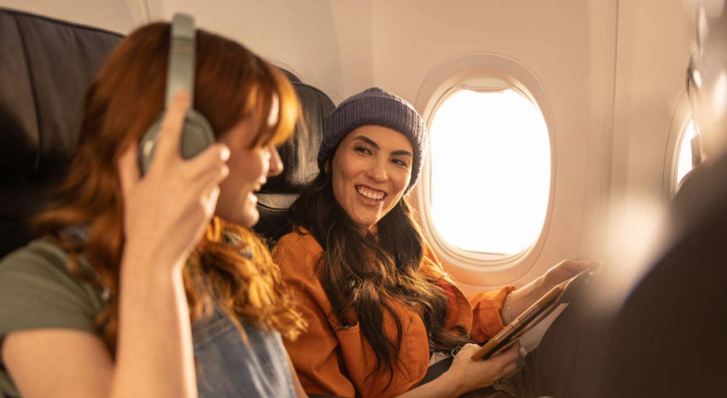 WestJet Baggage - two women on airplane talking
