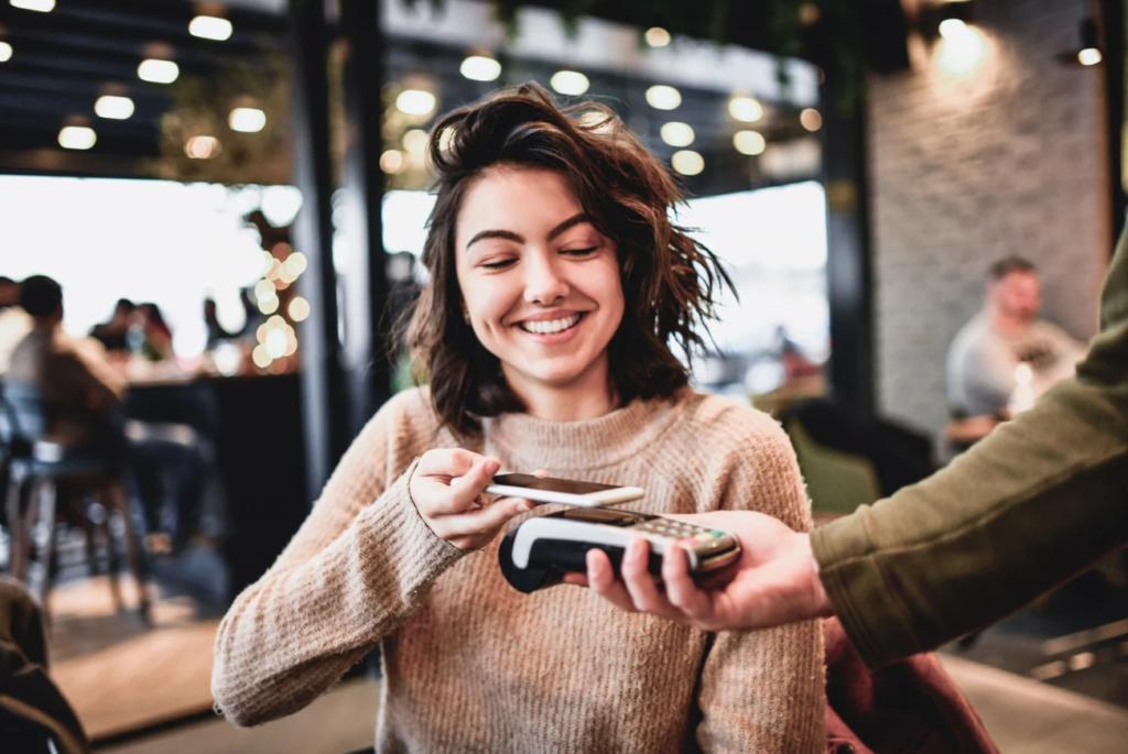8 Reasons BMO Ascend - Woman paying with phone at restaurant