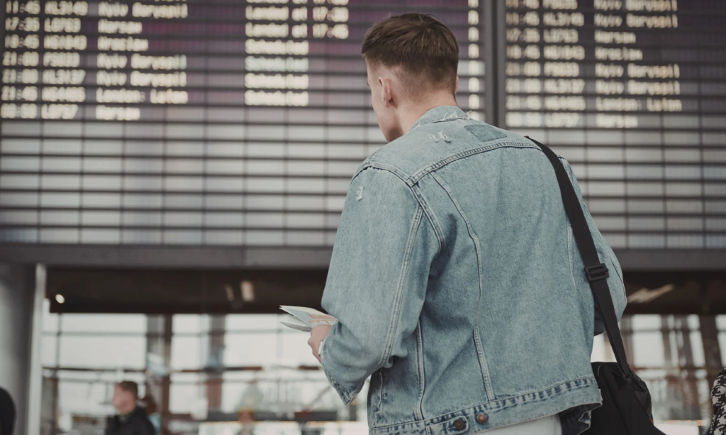Access YVR Lounges - person looking at airport departure board