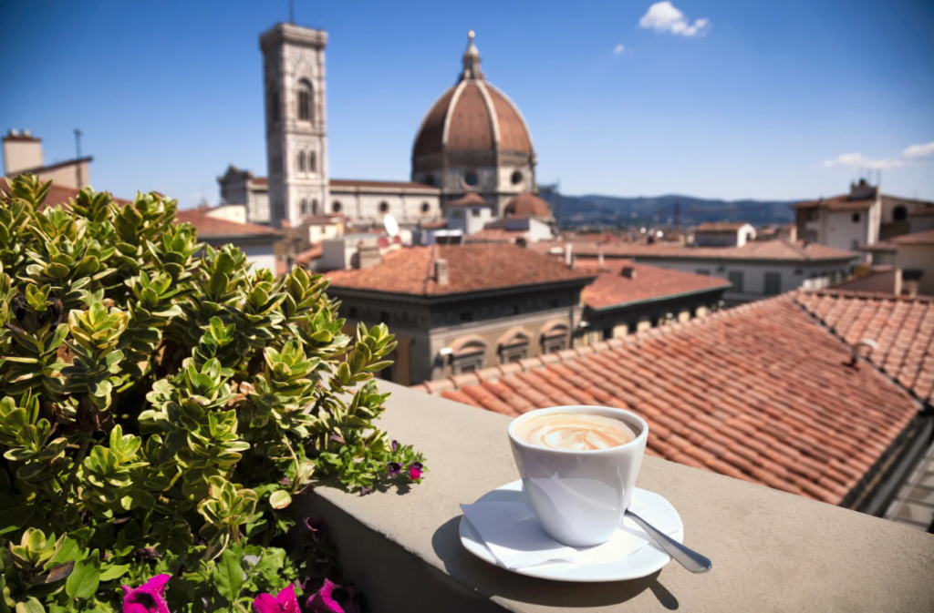Coffee on balcony overlooking european rooftops