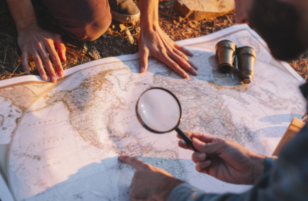 Look at a map with magnifying glass