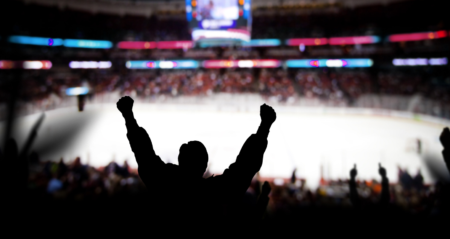 Fan cheering for their team in the stands during an NHL game