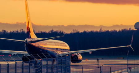 airplane on tarmac at sunset