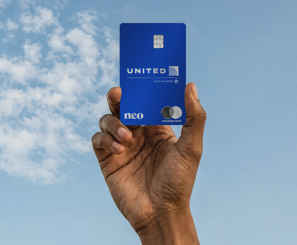 Hand holding up the United MileagePlus Neo credit card