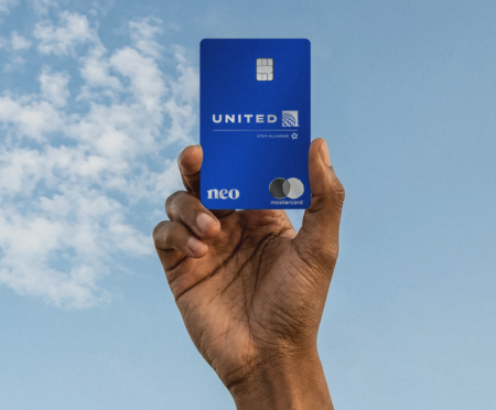 Hand holding up the United MileagePlus Neo credit card