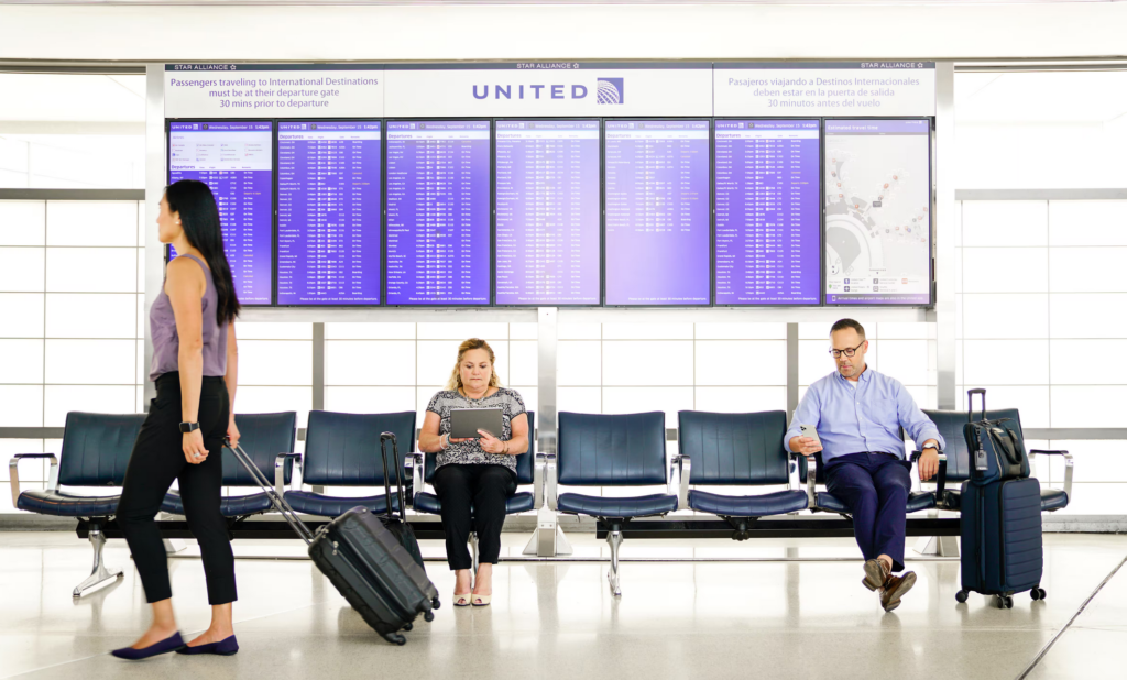 United terminal seating with United logo above passengers
