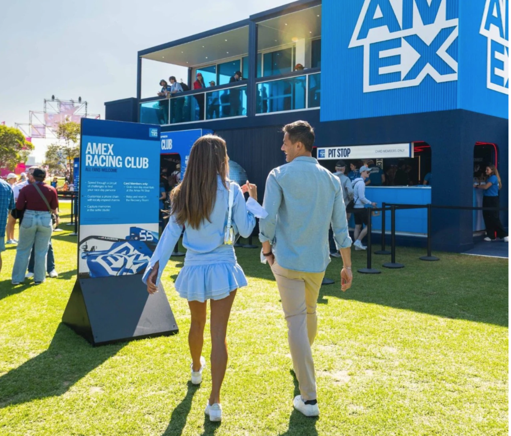 Amex F1 perks two people walking near Amex Pit Stop