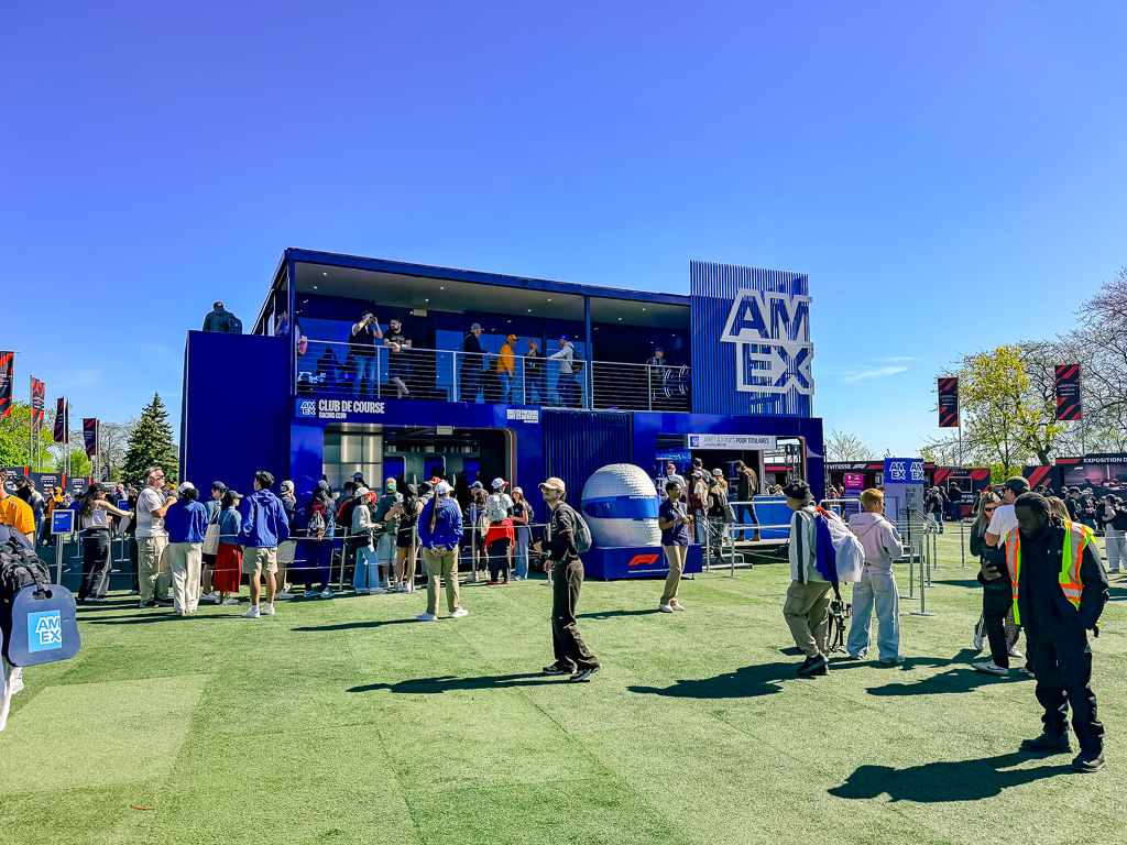 American Express pavilion at the Montreal F1 Grand Prix with a crowd in front of the main blue entrance