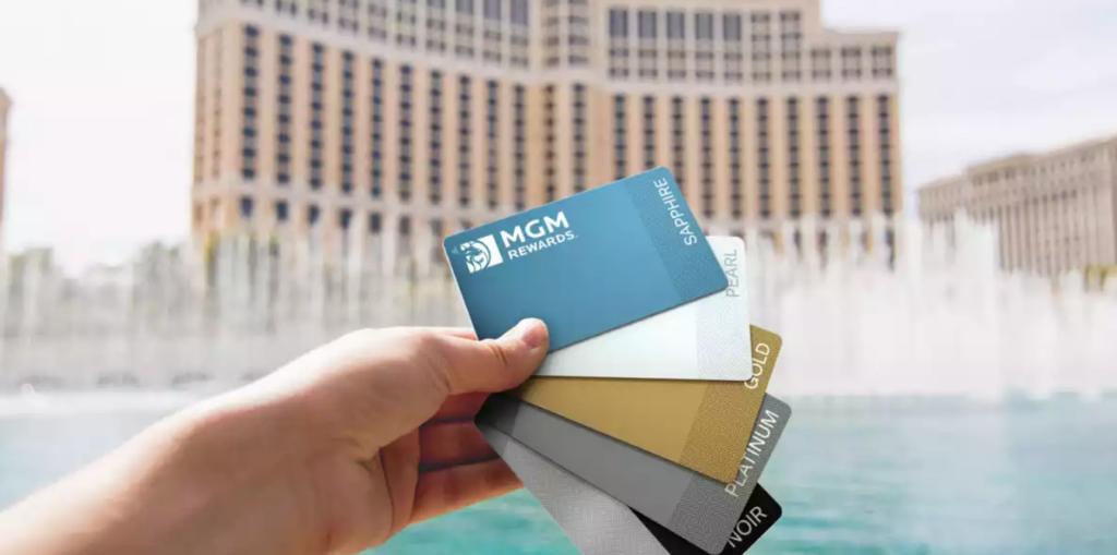MGM Rewards cards in hand in front of fountain