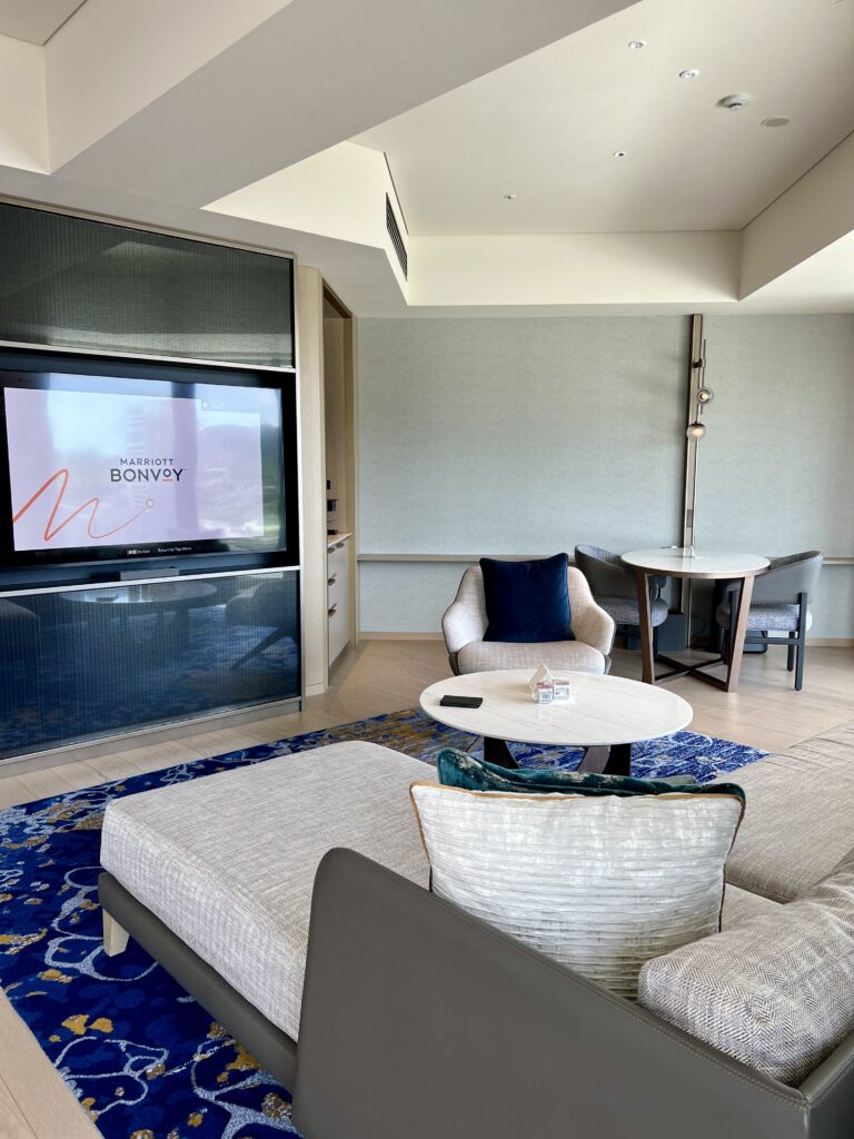 Salon executive d'une suite du marriott nagasaki avec canapé modulable et vue panoramique sur la baie de Nagasaki