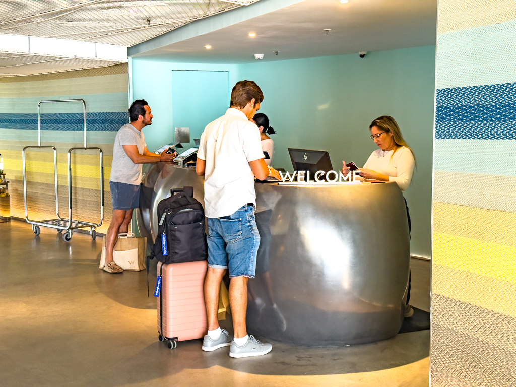 Reception moderne du w ibiza avec comptoir design gris et accueil chaleureux pour les clients