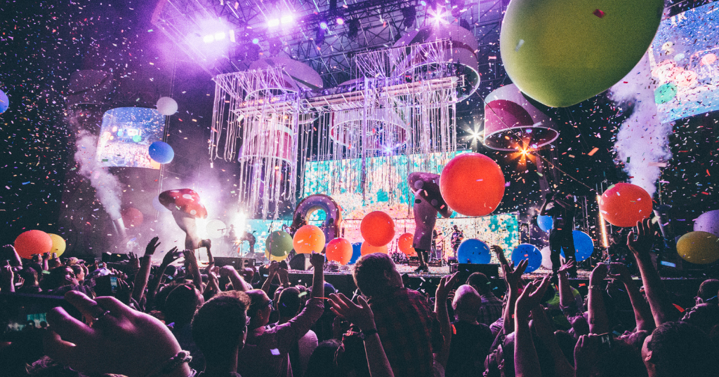 large concert or event with crowd stage balloons