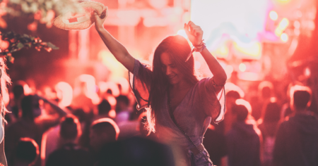 person with hands in the air at concert