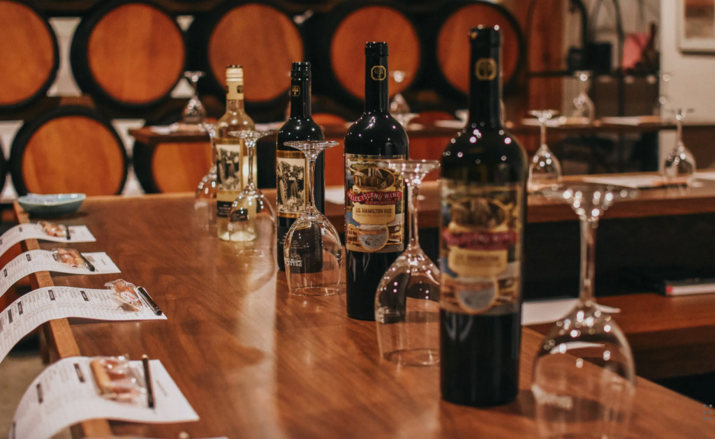 Pelee island wine tasting - bottles, glasses, and menus on wooden table