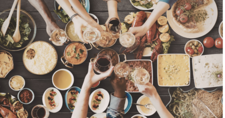 Overhead view of friends sharing a meal at a restaurant table