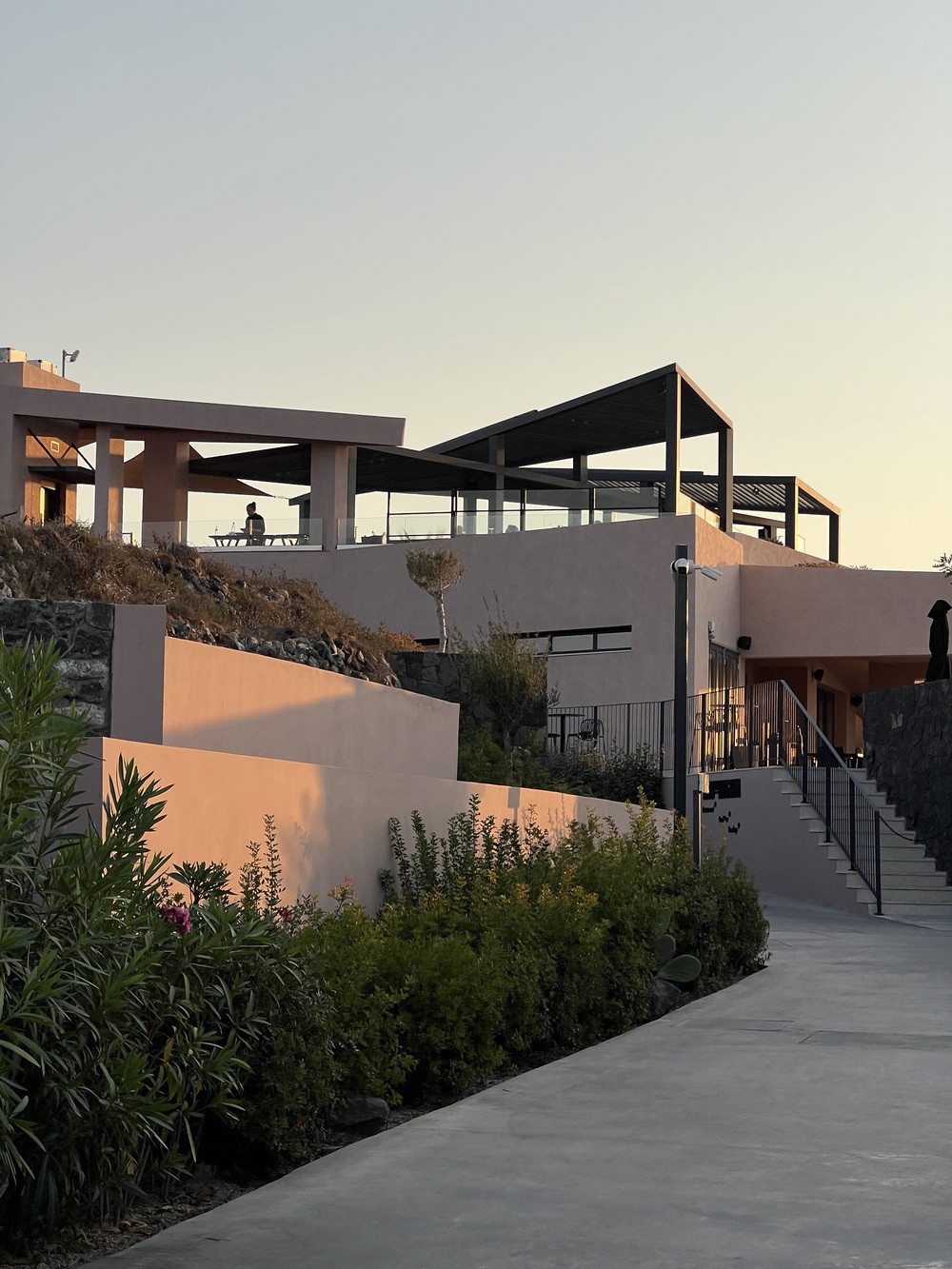 Architecture of the Domes Novos Santorini hotel at sunset