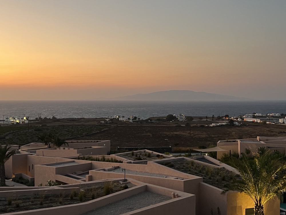 Sunset over the bungalows and sea from Domes Novos Santorini