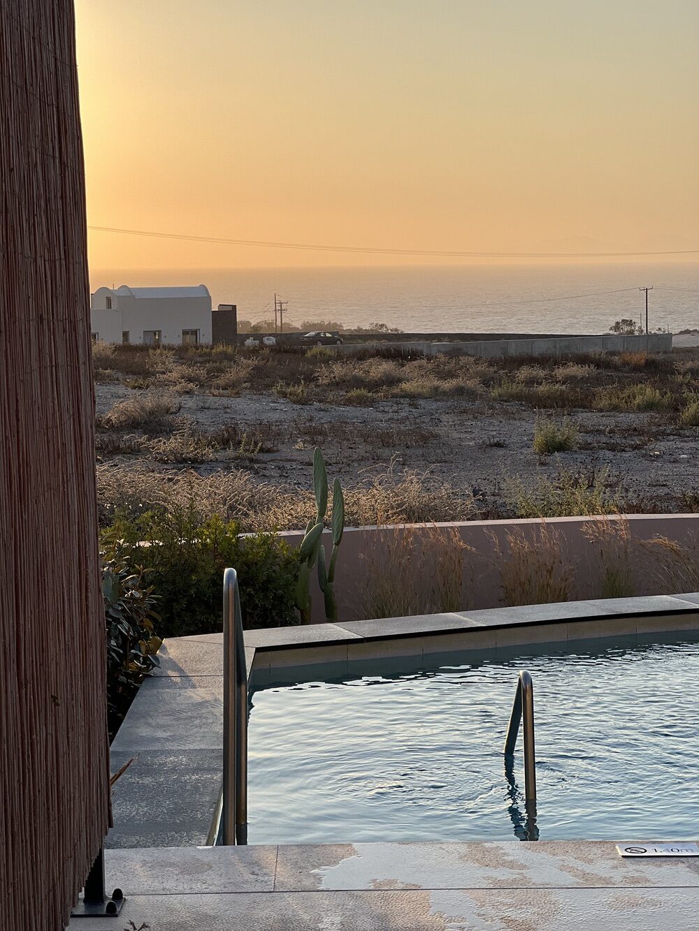 Private terrace with pool at sunset at Domes Novos Santorini