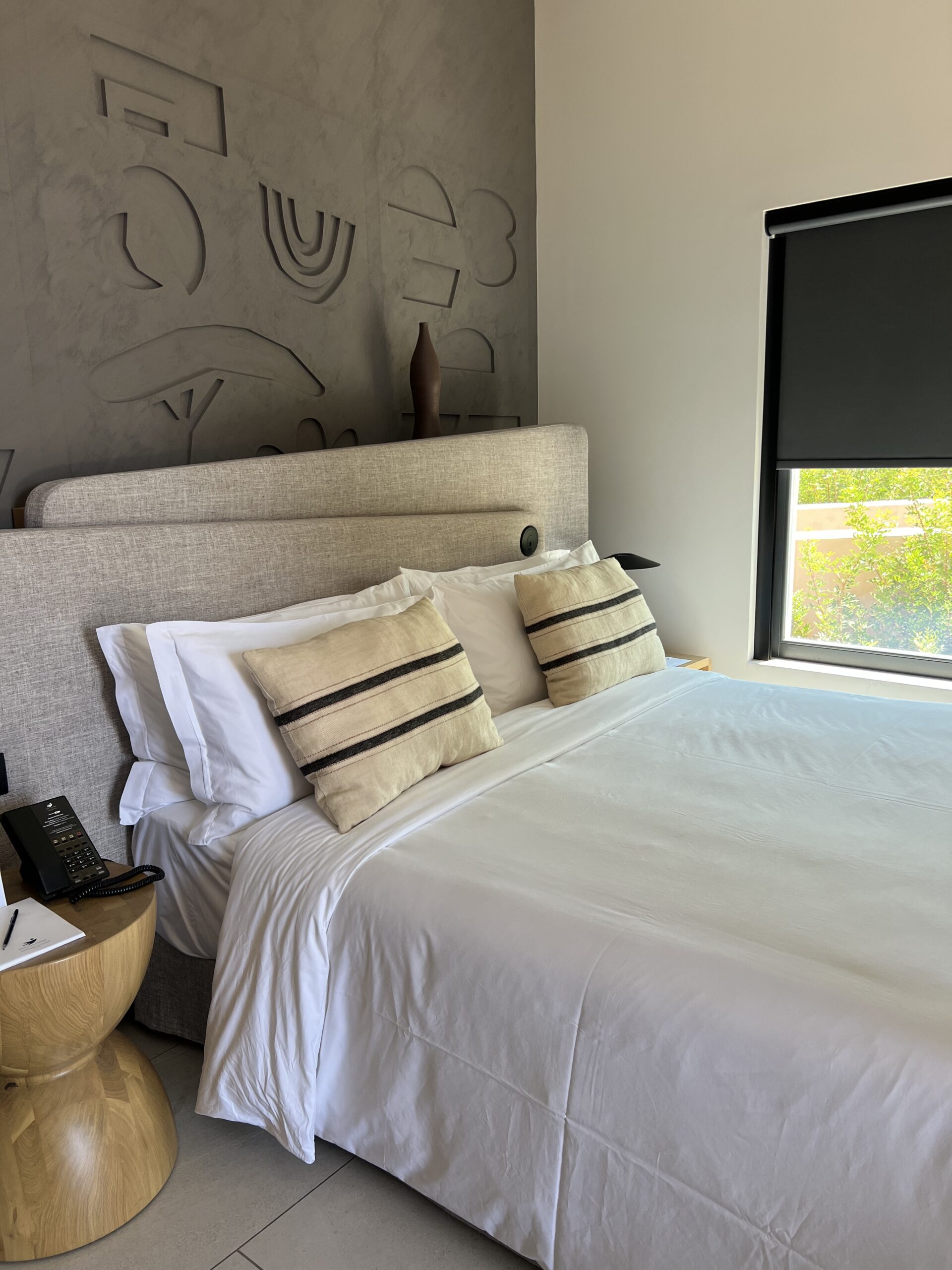 King bed and carved headboard in the Senses Bungalow room