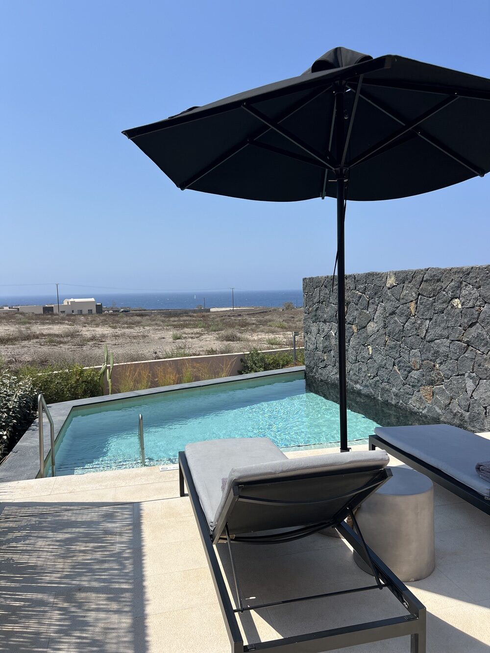 Private terrace with pool, parasol, and sea view