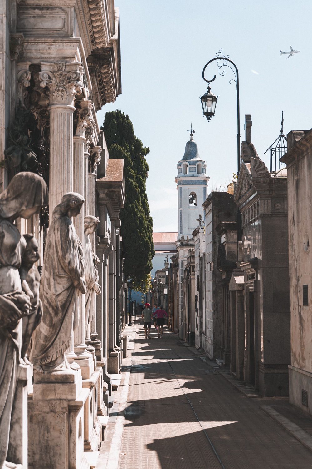 Recoleta Cemetery walkway with statues and bell tower