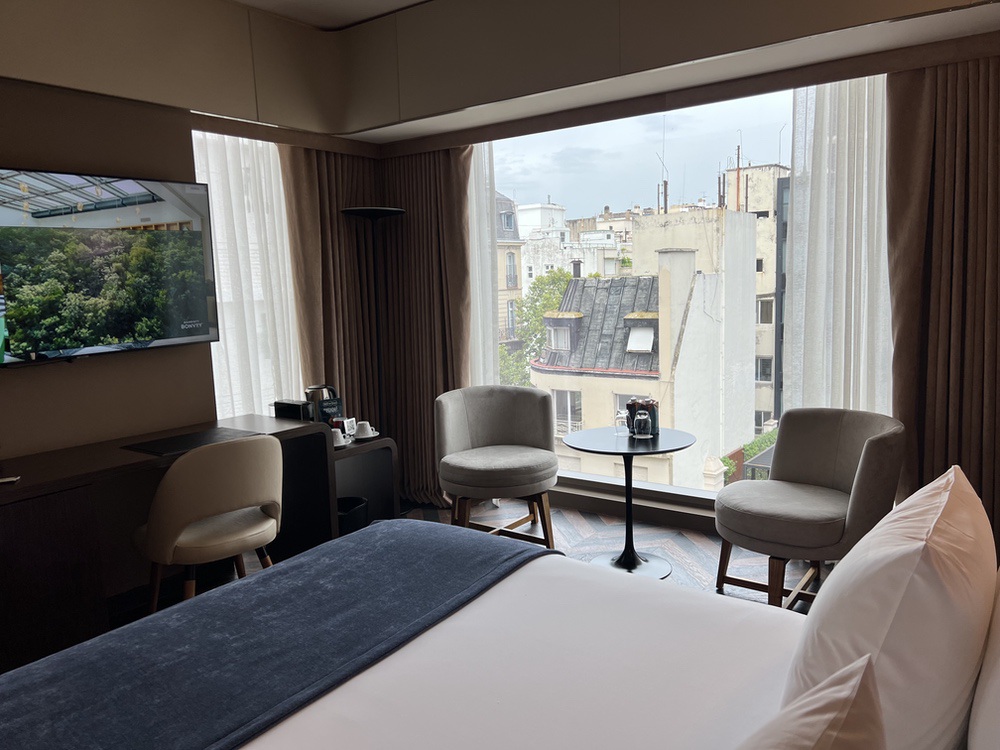 Room seating area with views over Parisian-style rooftops