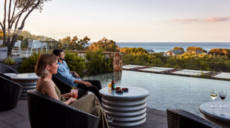 ALL Accor couple sitting poolside overlooking ocean
