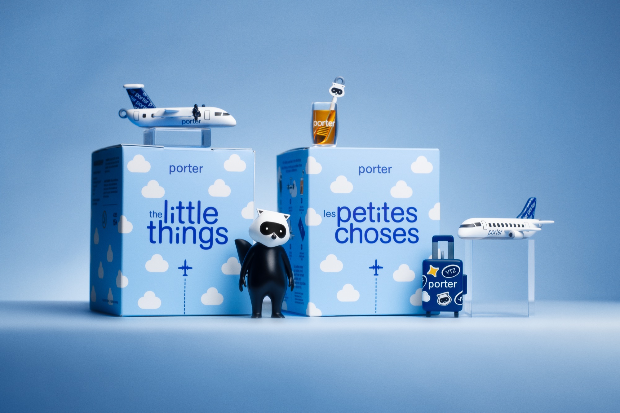 Porter Airlines “Little Things” mystery boxes, 20th anniversary edition, with mascot figurine, miniature plane, glass, and luggage