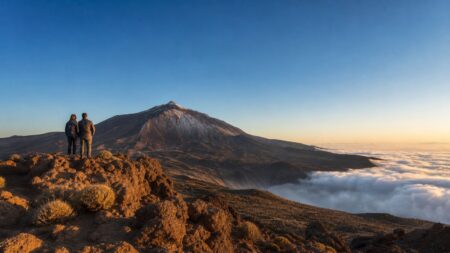 Two travellers looking at Mount Teide and the sea of clouds in Tenerife